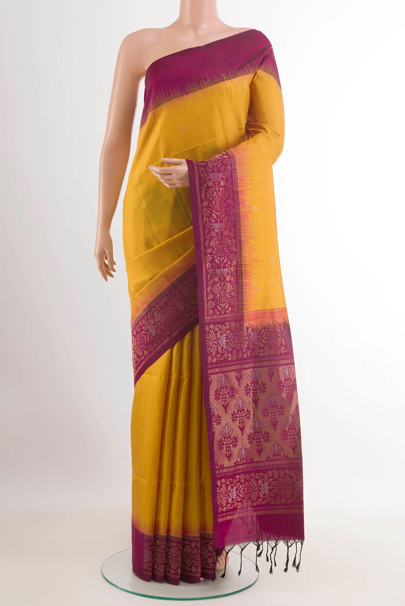 Yellow Soft Silk Saree with Zari Butta on the body and Zari Border.  displayed on a mannequin