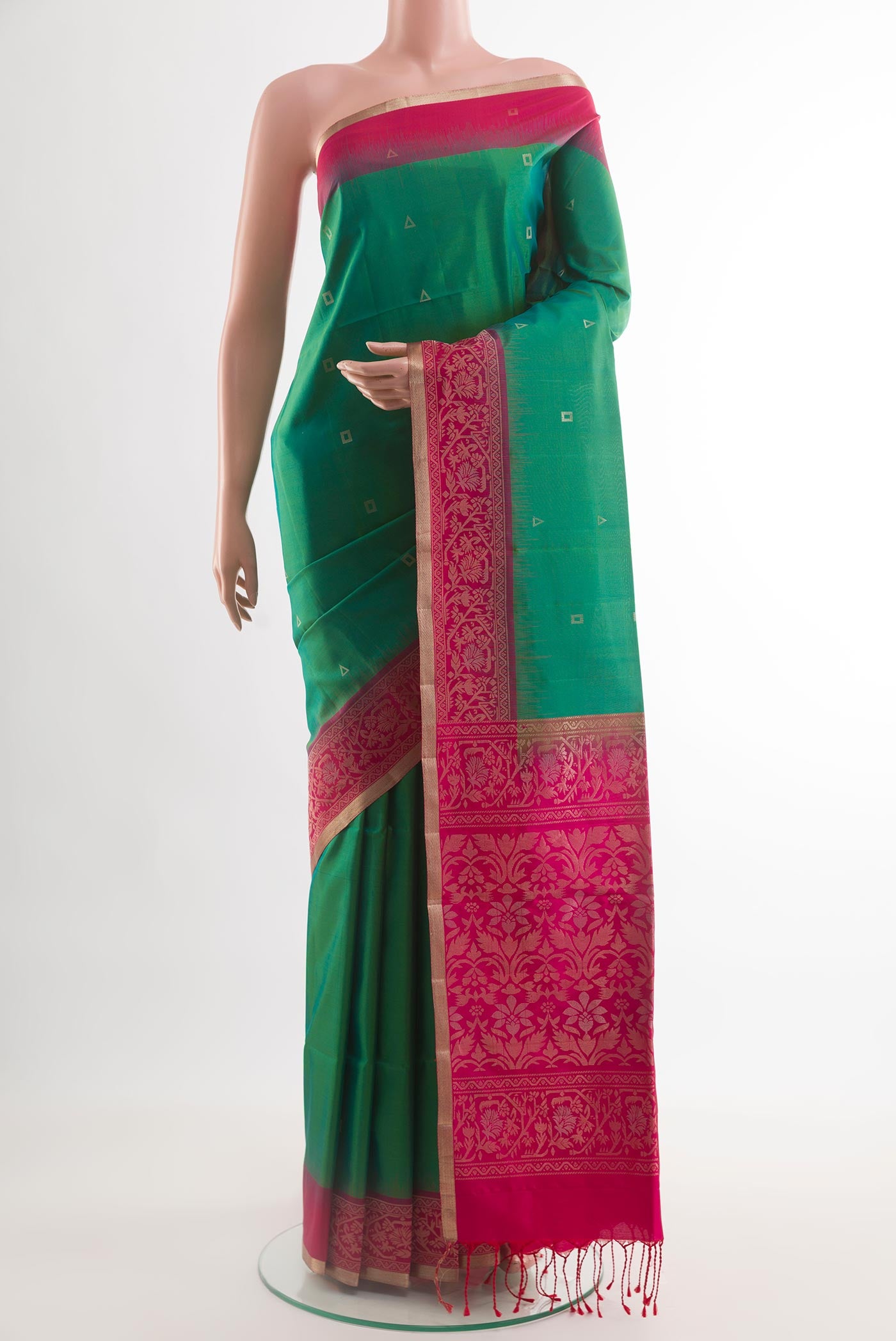 Green Soft Silk Saree with Zari Butta on the body and Zari Border.  displayed on a mannequin
