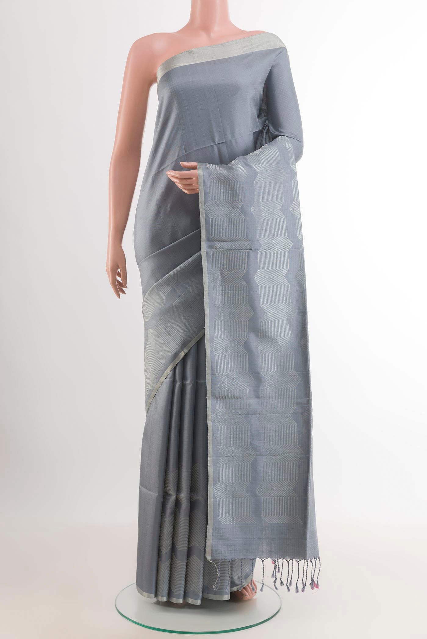 Grey Soft Silk Saree with Zari Butta on the body and Zari Border.  displayed on a mannequin