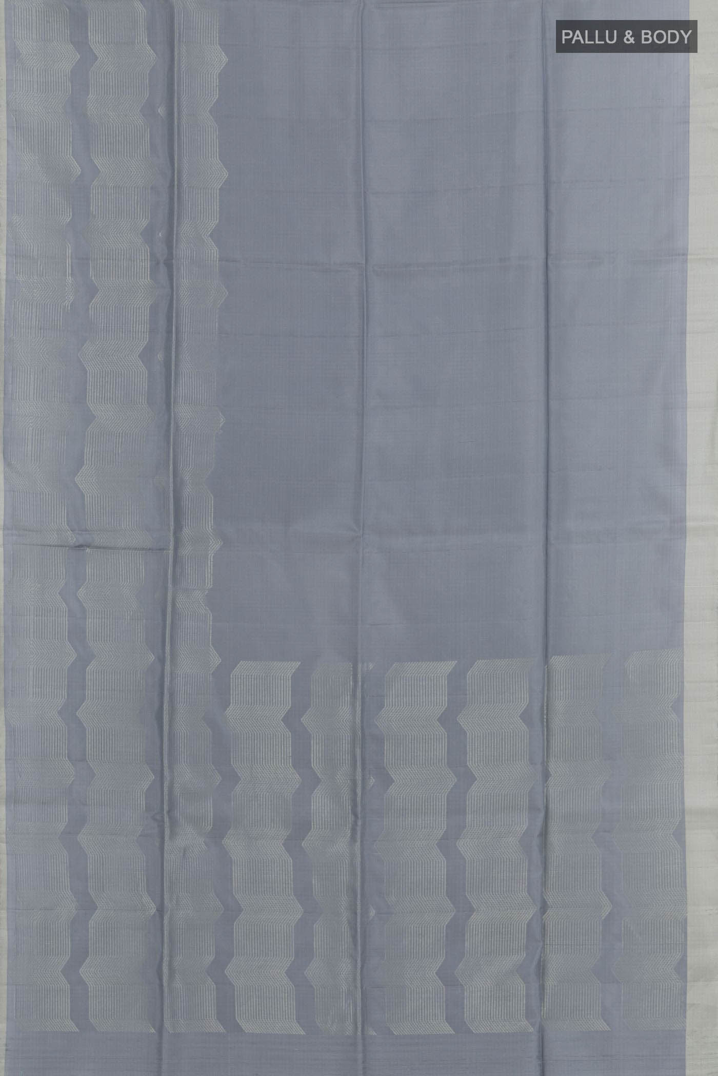 Flat view of Grey Soft Silk Saree with Zari Butta on the body and Zari Border. 