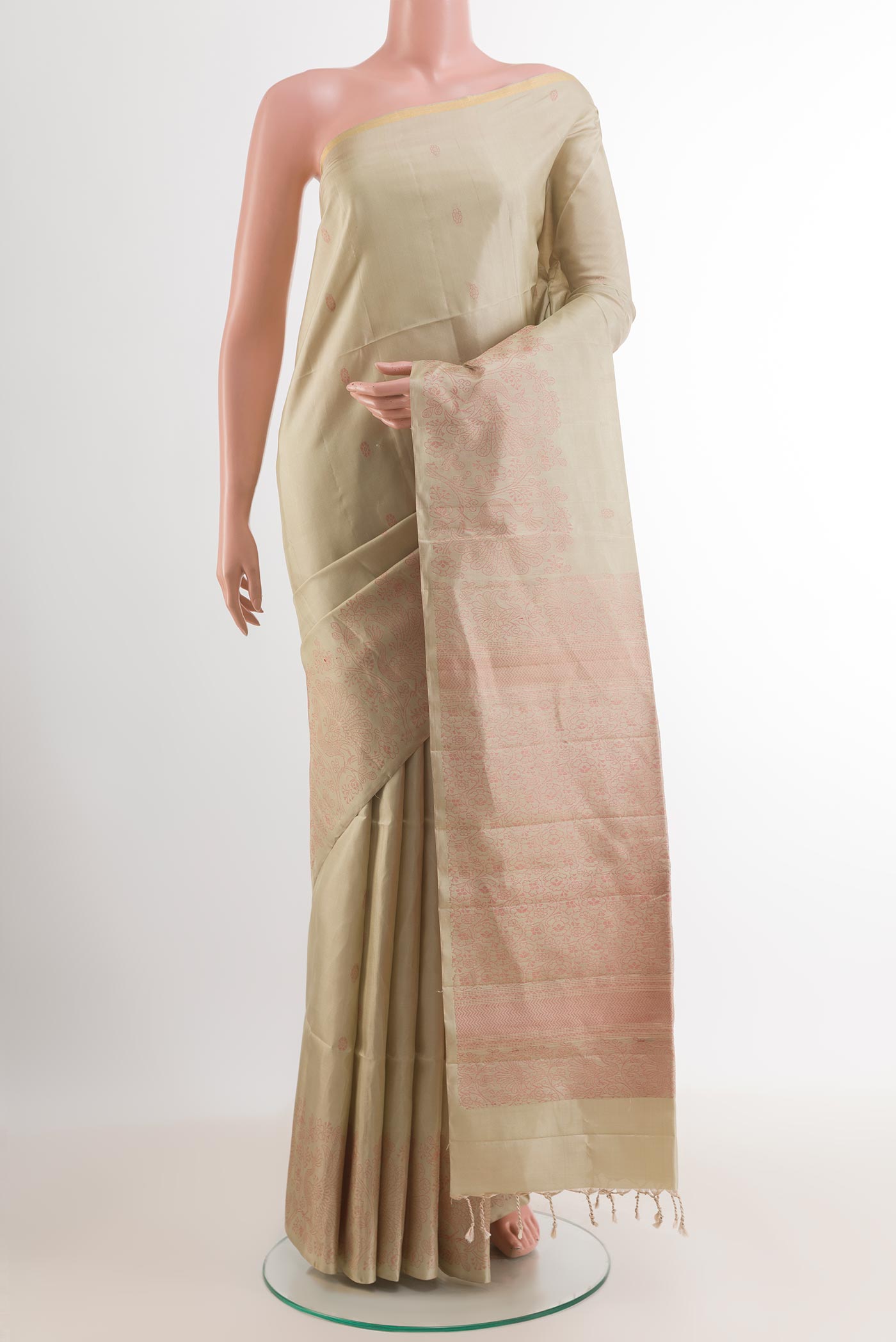 Cream Soft Silk Saree with Thread Butta on the body and Zari Border.  displayed on a mannequin
