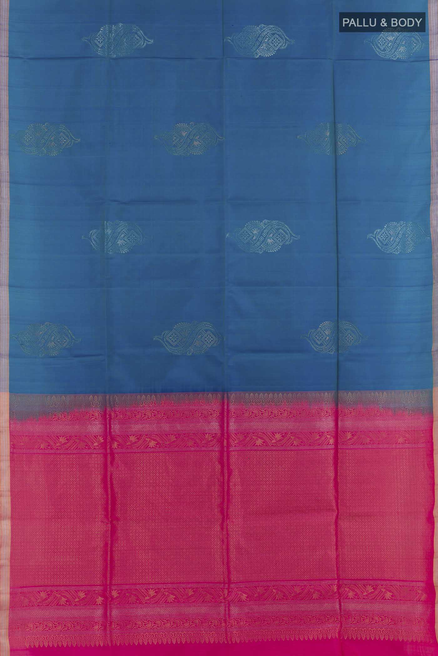 Flat view of Peacock Blue Soft Silk Saree with Zari Butta on the body and Zari Border. 
