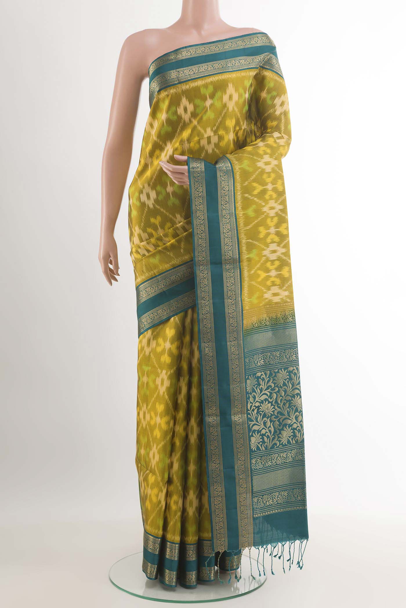 Mehandi Green Soft Silk Saree with Ikat design on the body and Zari Border.  displayed on a mannequin