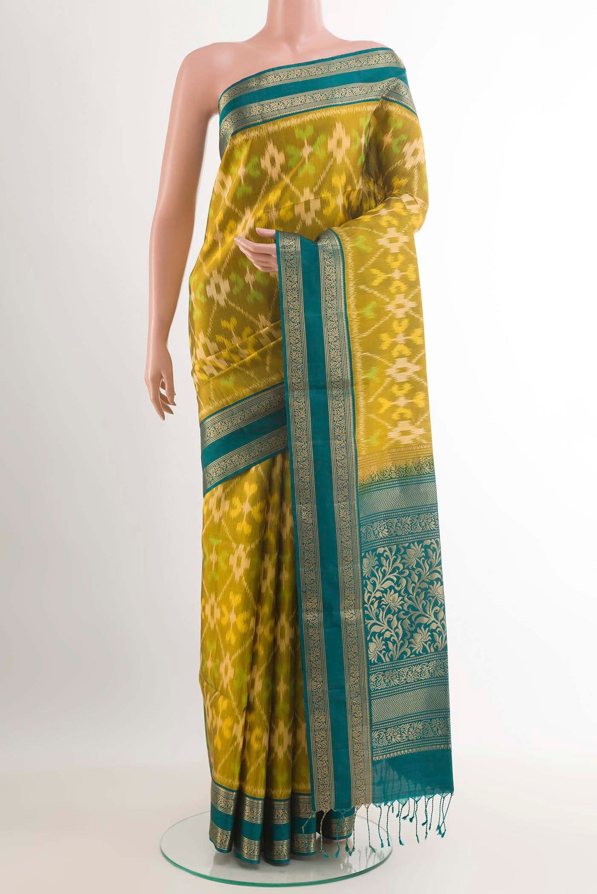 Mehandi Green Soft Silk Saree with Ikat design on the body and Zari Border.  displayed on a mannequin