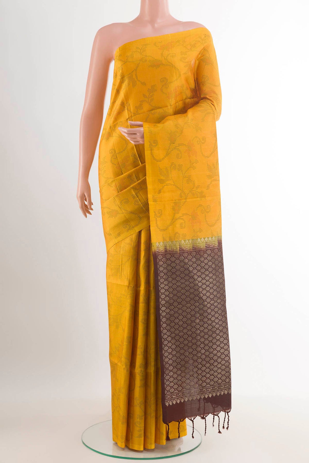 Yellow Soft Silk Saree with Jacquard design on the body and Zari Border.  displayed on a mannequin