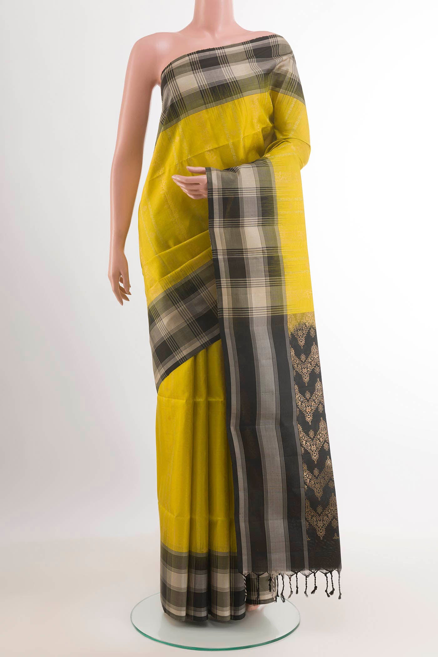 Yellow Soft Silk Saree with Zari Butta on the body and Zari Border.  displayed on a mannequin