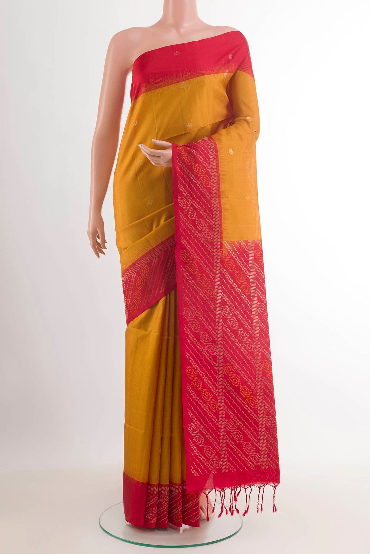 Yellow Soft Silk Saree with Zari Butta on the body and Zari Border.  displayed on a mannequin