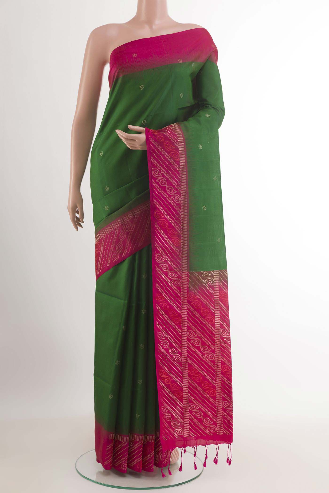 Green Soft Silk Saree with Zari Butta on the body and Zari Border.  displayed on a mannequin