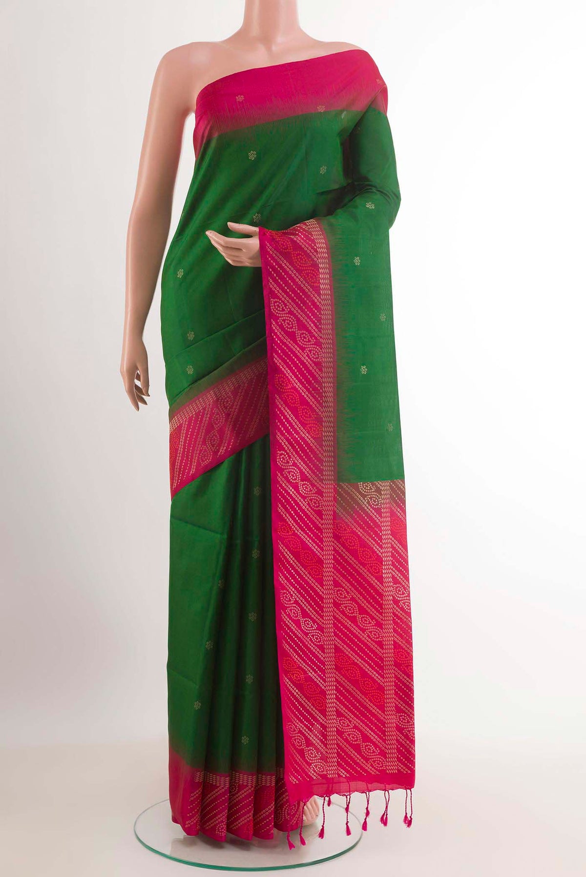 Green Soft Silk Saree with Zari Butta on the body and Zari Border.  displayed on a mannequin