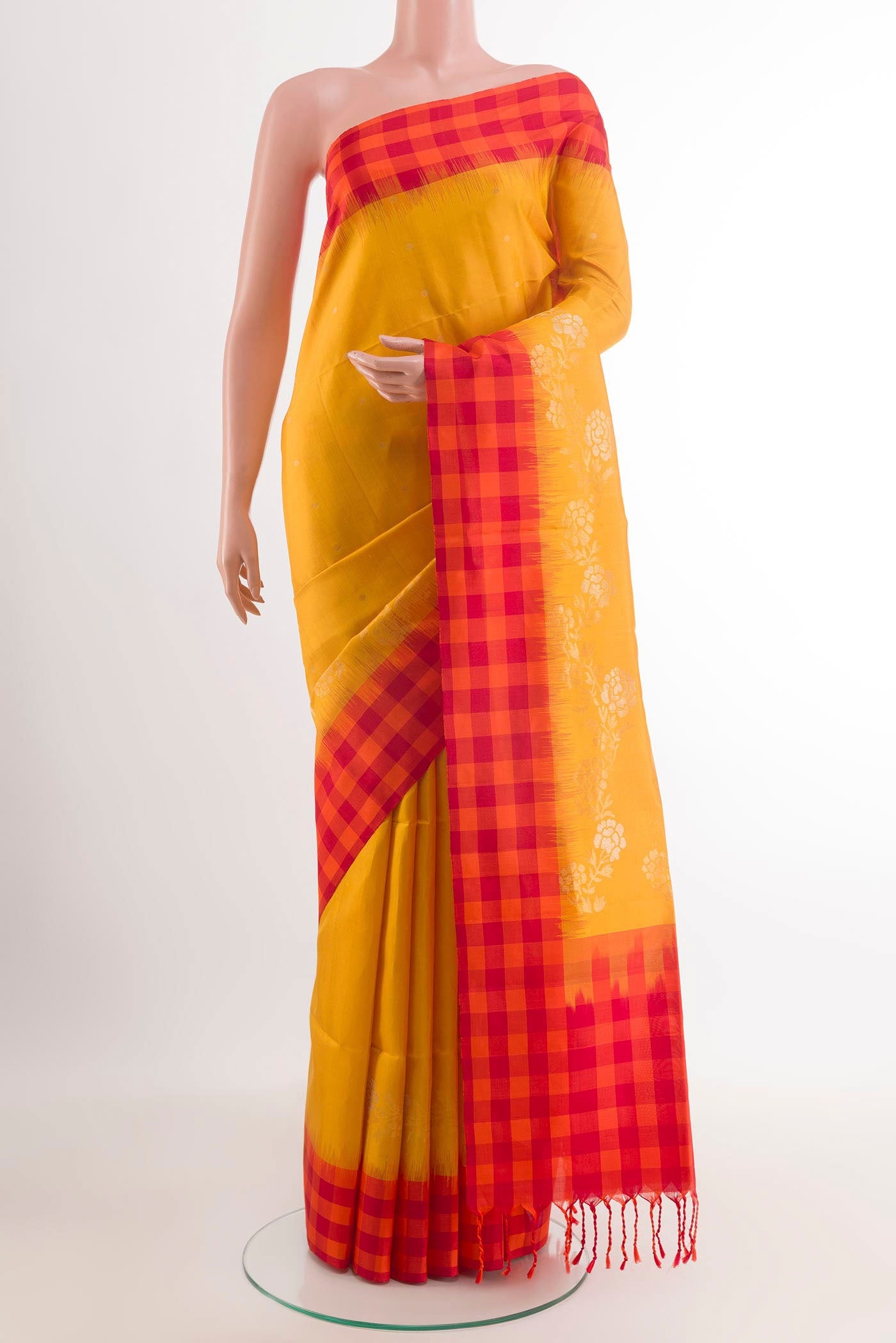 Yellow Soft Silk Saree with Zari Butta on the body and Zari Border.  displayed on a mannequin