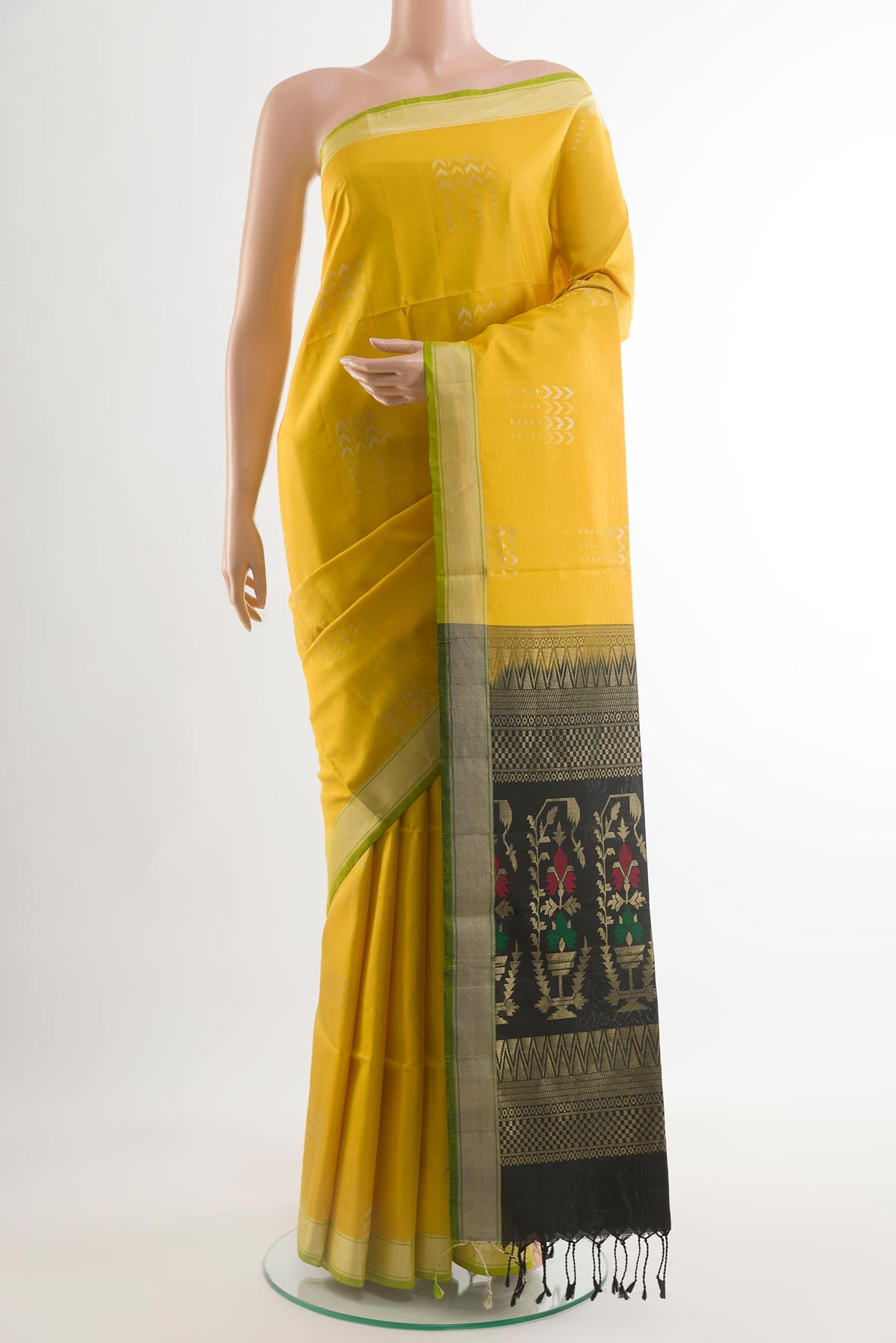 Yellow Soft Silk Saree with Zari Butta on the body and Zari Border.  displayed on a mannequin