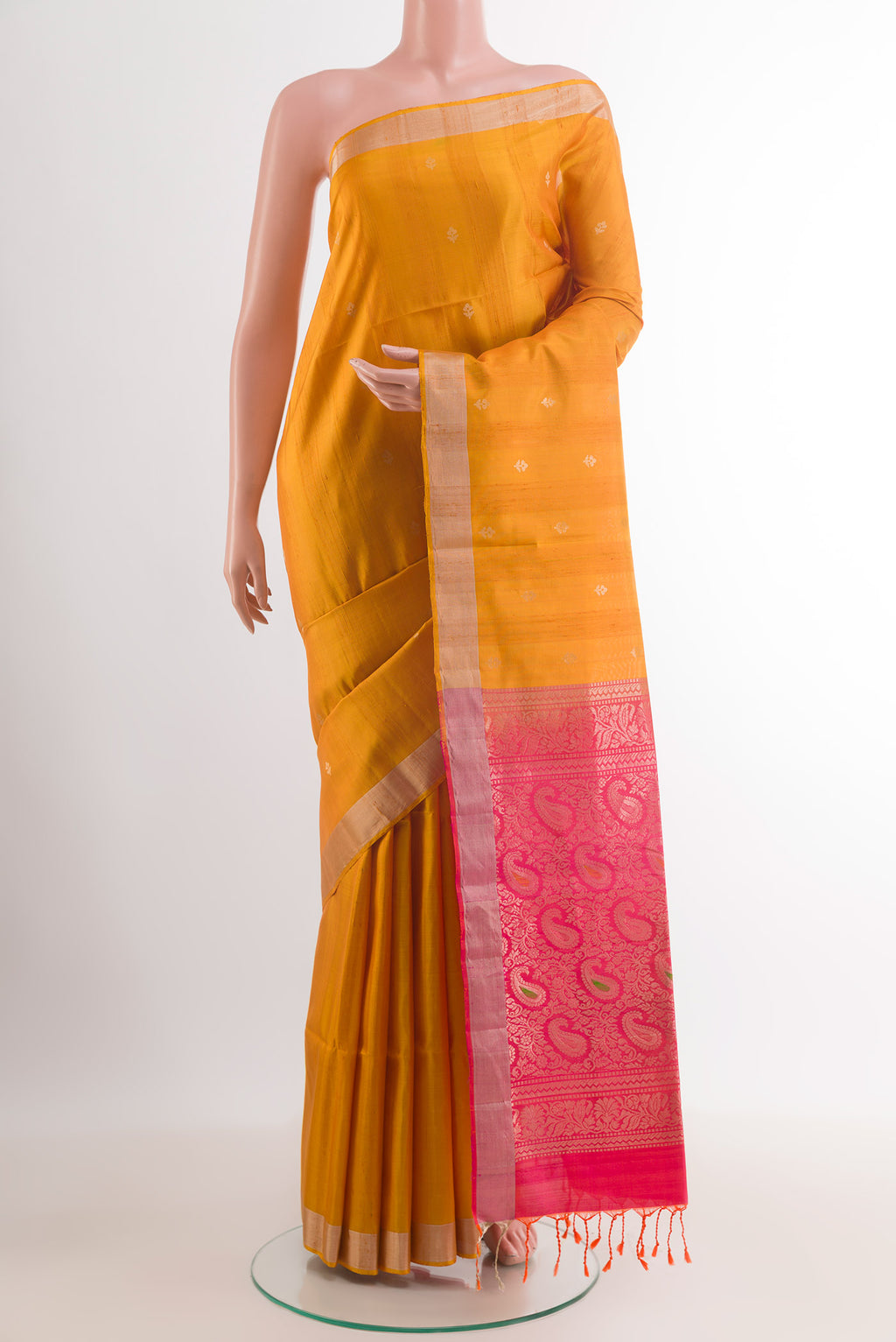 Yellow Soft Silk Saree with Zari Butta on the body and Zari Border.  displayed on a mannequin