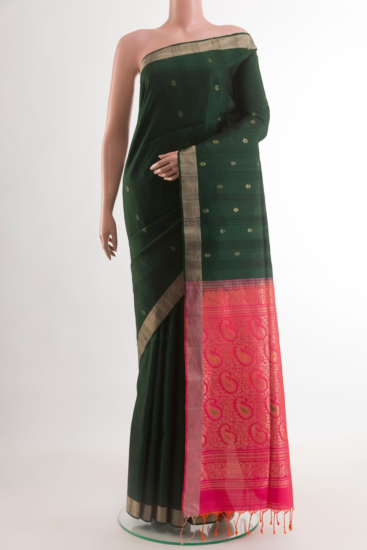 Bottle Green Kanjivaram Silk Saree with Zari Butta on the body and Zari Border.  displayed on a mannequin