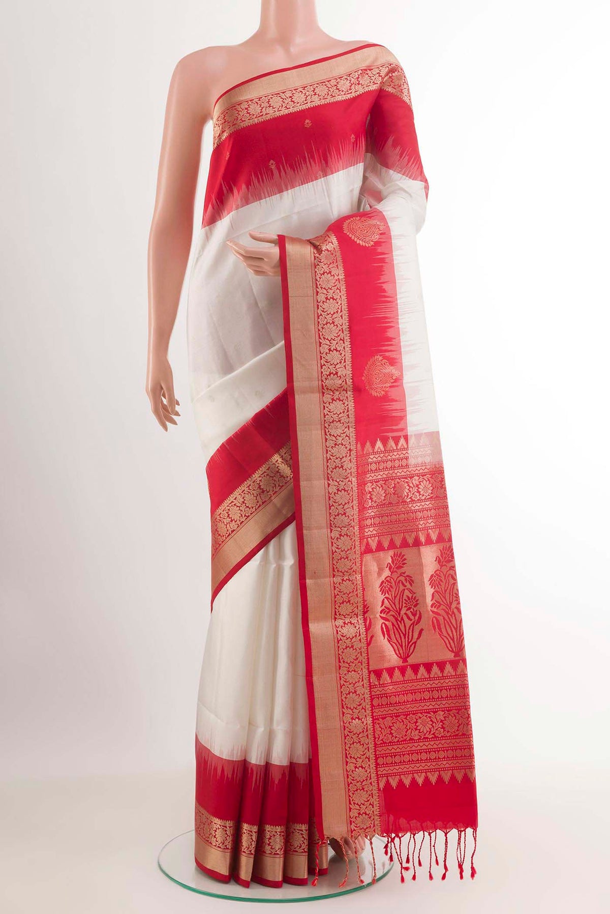 Off White Soft Silk Saree with Zari Butta on the body and Zari Border.  displayed on a mannequin