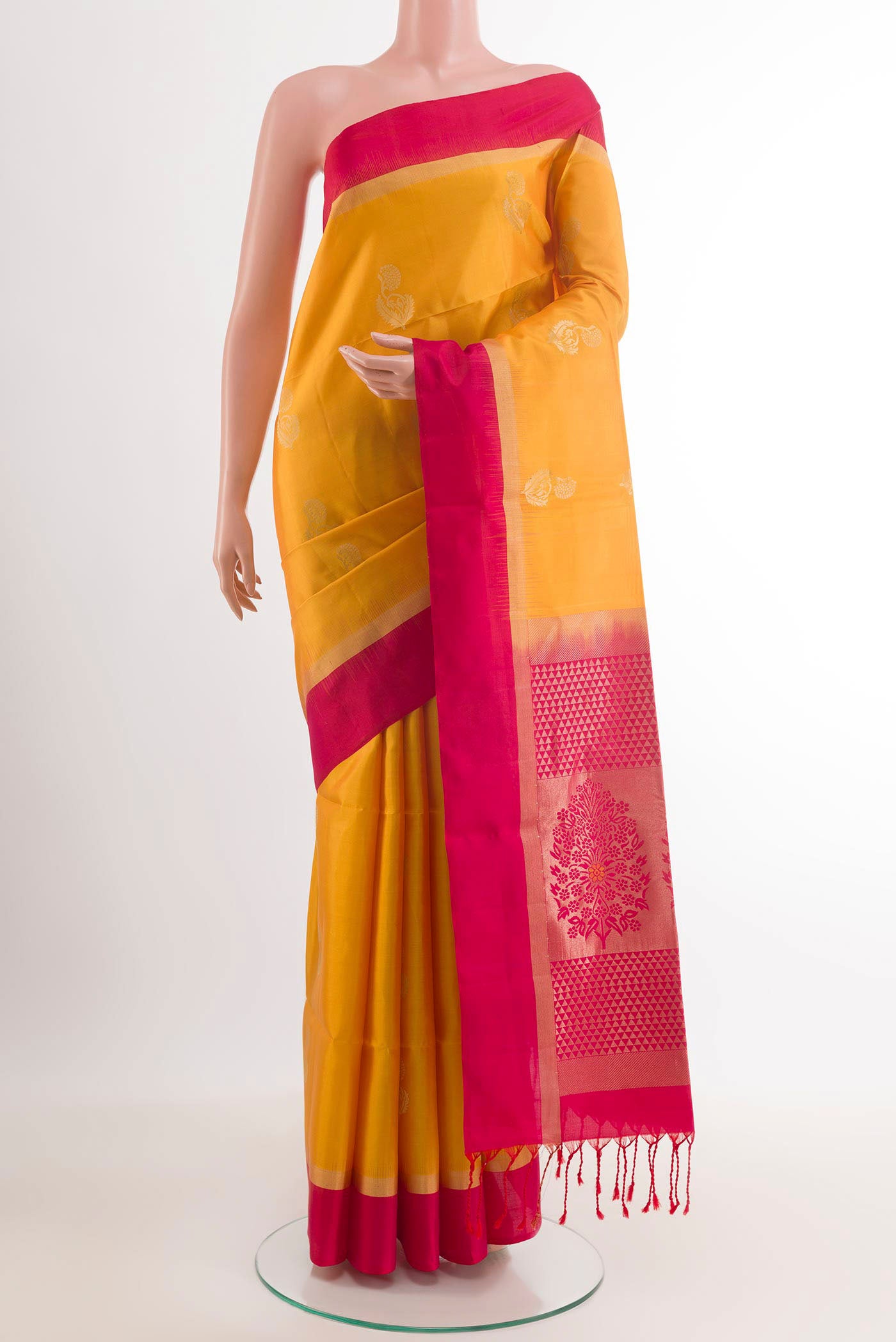 Yellow Soft Silk Saree with Zari Butta on the body and Zari Border.  displayed on a mannequin
