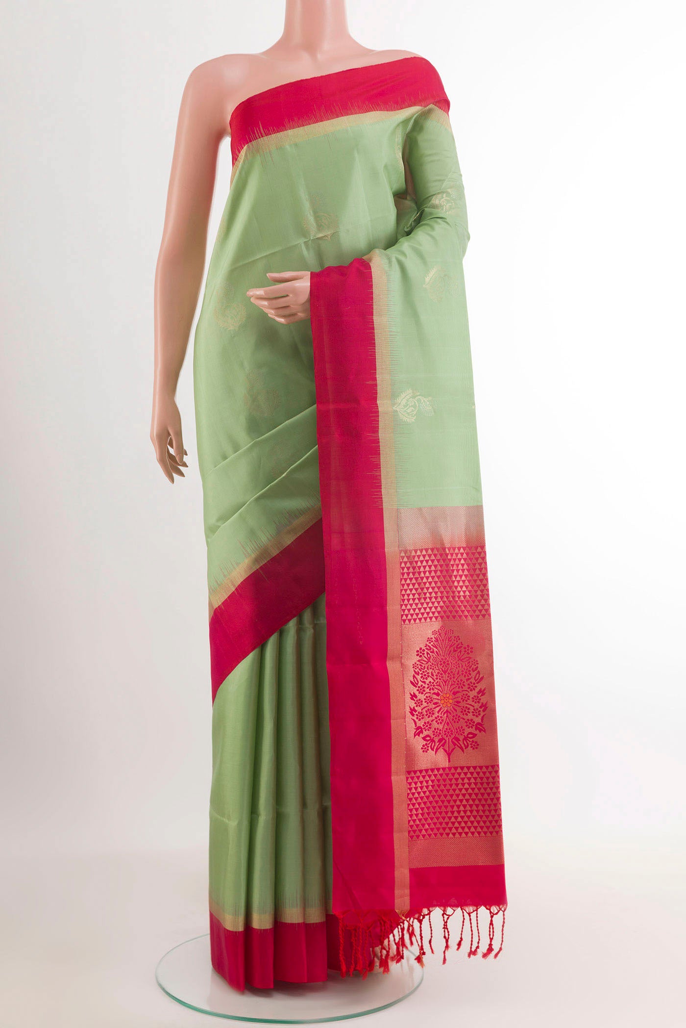 Pista Green Soft Silk Saree with Zari Butta on the body and Zari Border.  displayed on a mannequin