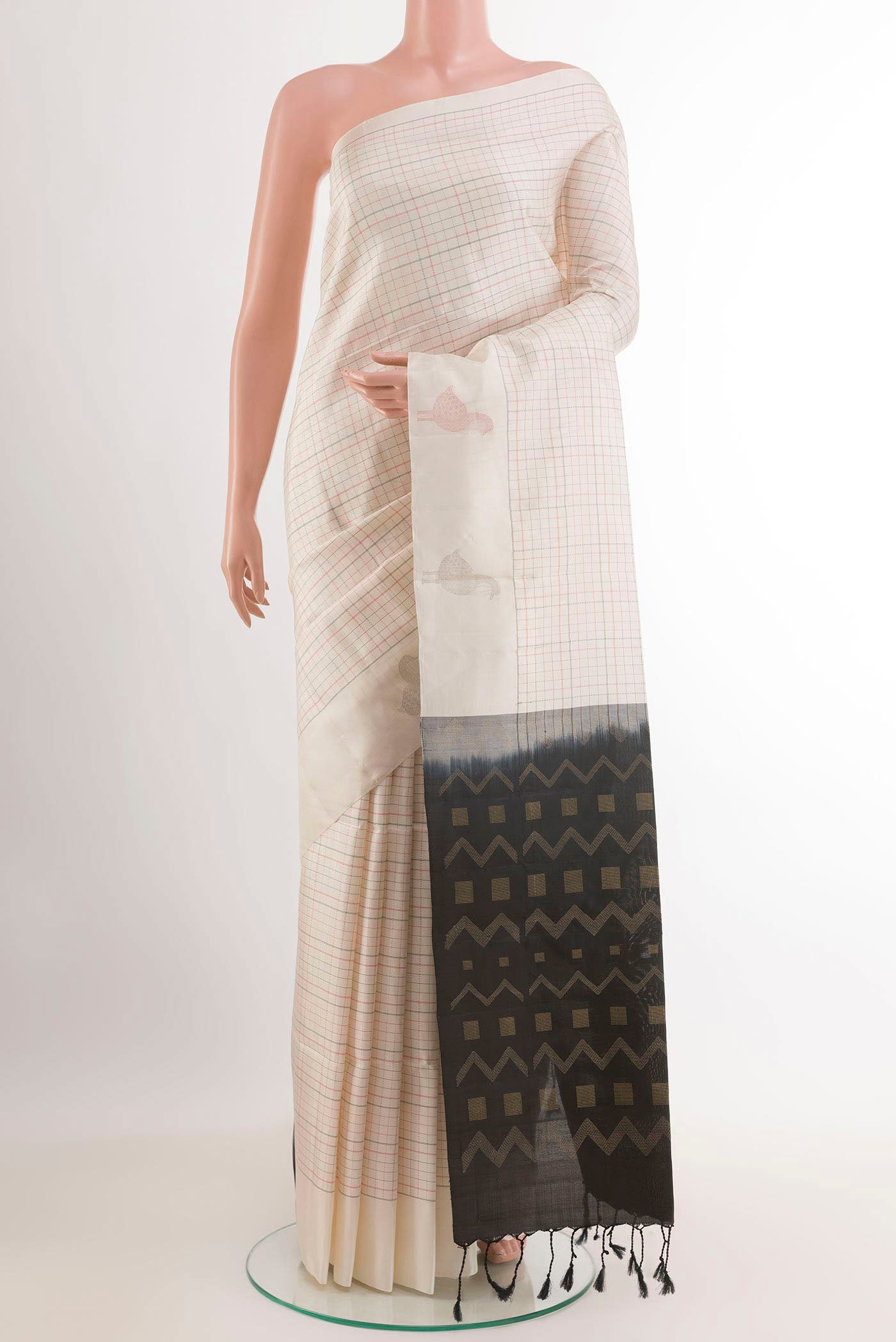 Off White Soft Silk Saree with Checked design on the body and Zari Border.  displayed on a mannequin