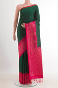 Bottle Green Soft Silk Saree with Zari Butta on the body and Zari Border.  displayed on a mannequin