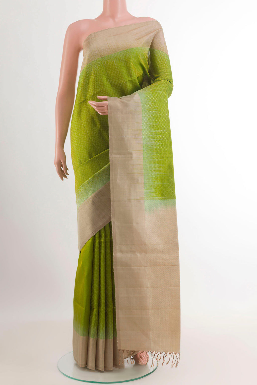 Green Soft Silk Saree with Zari Butta on the body and Zari Border.  displayed on a mannequin