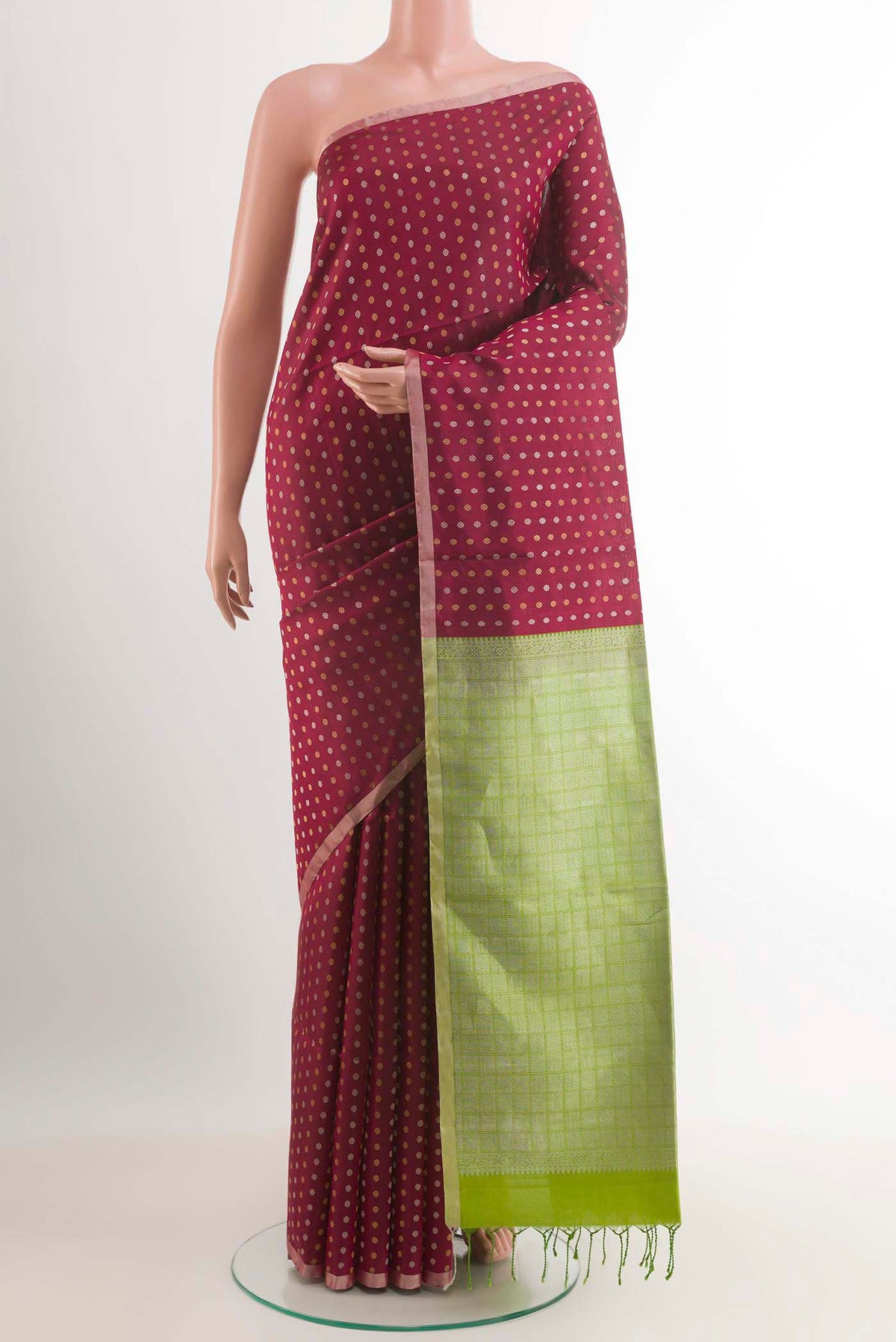 Maroon Soft Silk Saree with Zari Butta on the body and Zari Border.  displayed on a mannequin