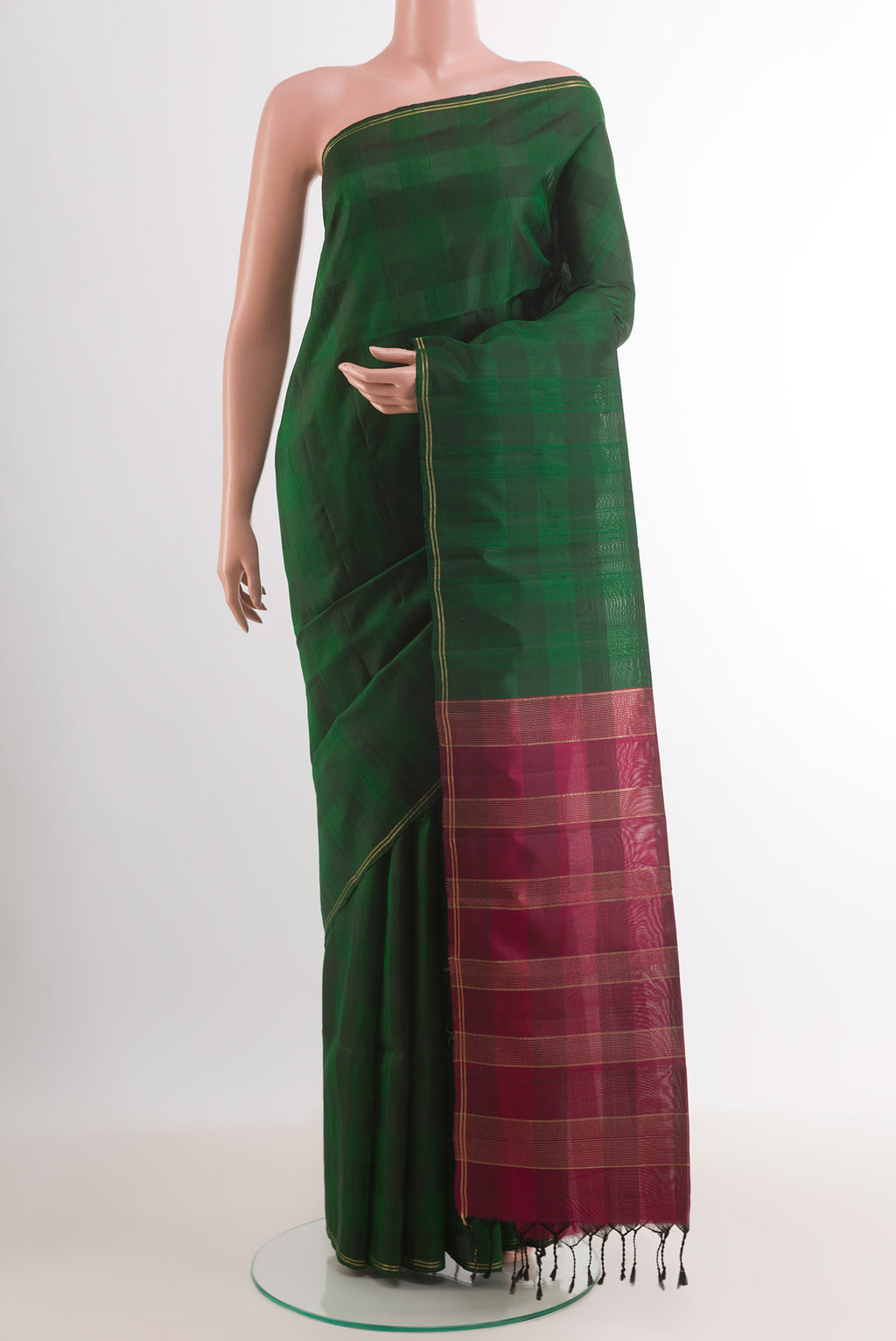 Bottle Green Soft Silk Saree with Checked design on the body and Zari Border.  displayed on a mannequin