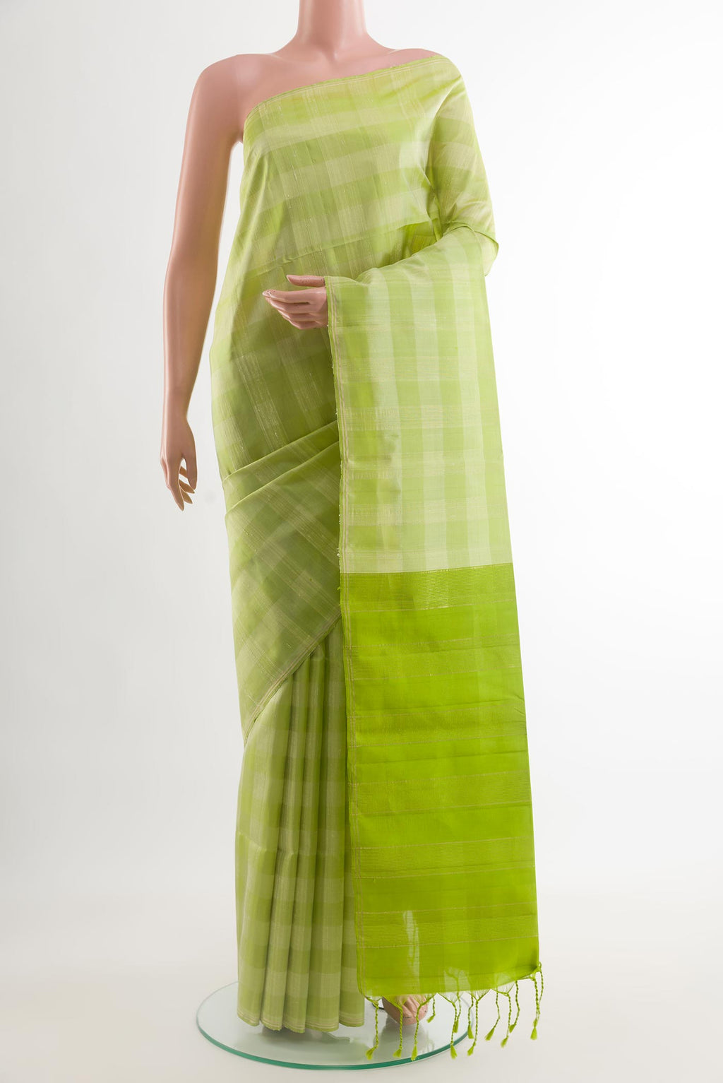 Light Green Soft Silk Saree with Checked design on the body and Zari Border.  displayed on a mannequin