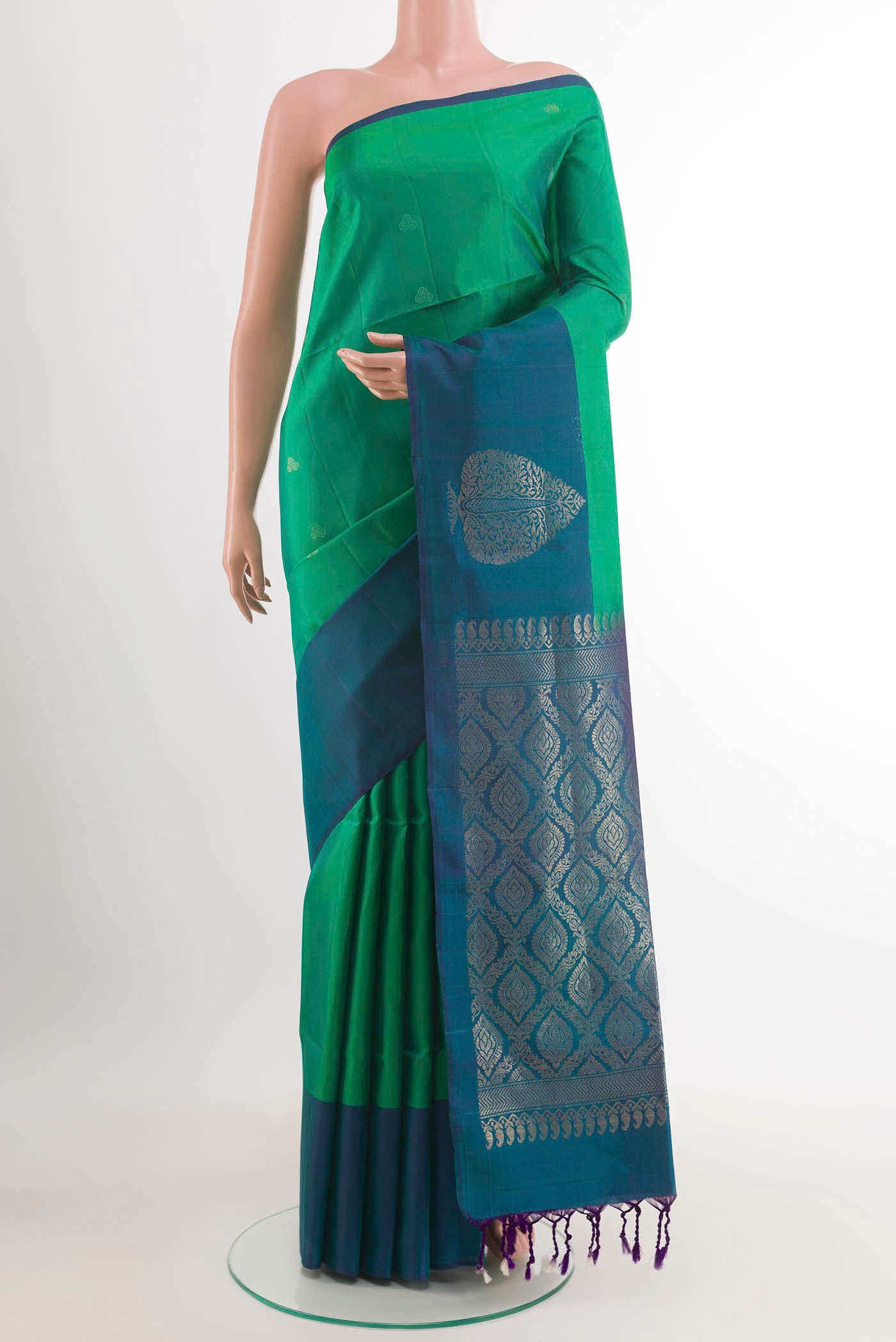Green Soft Silk Saree with Zari Butta on the body and Zari Border.  displayed on a mannequin