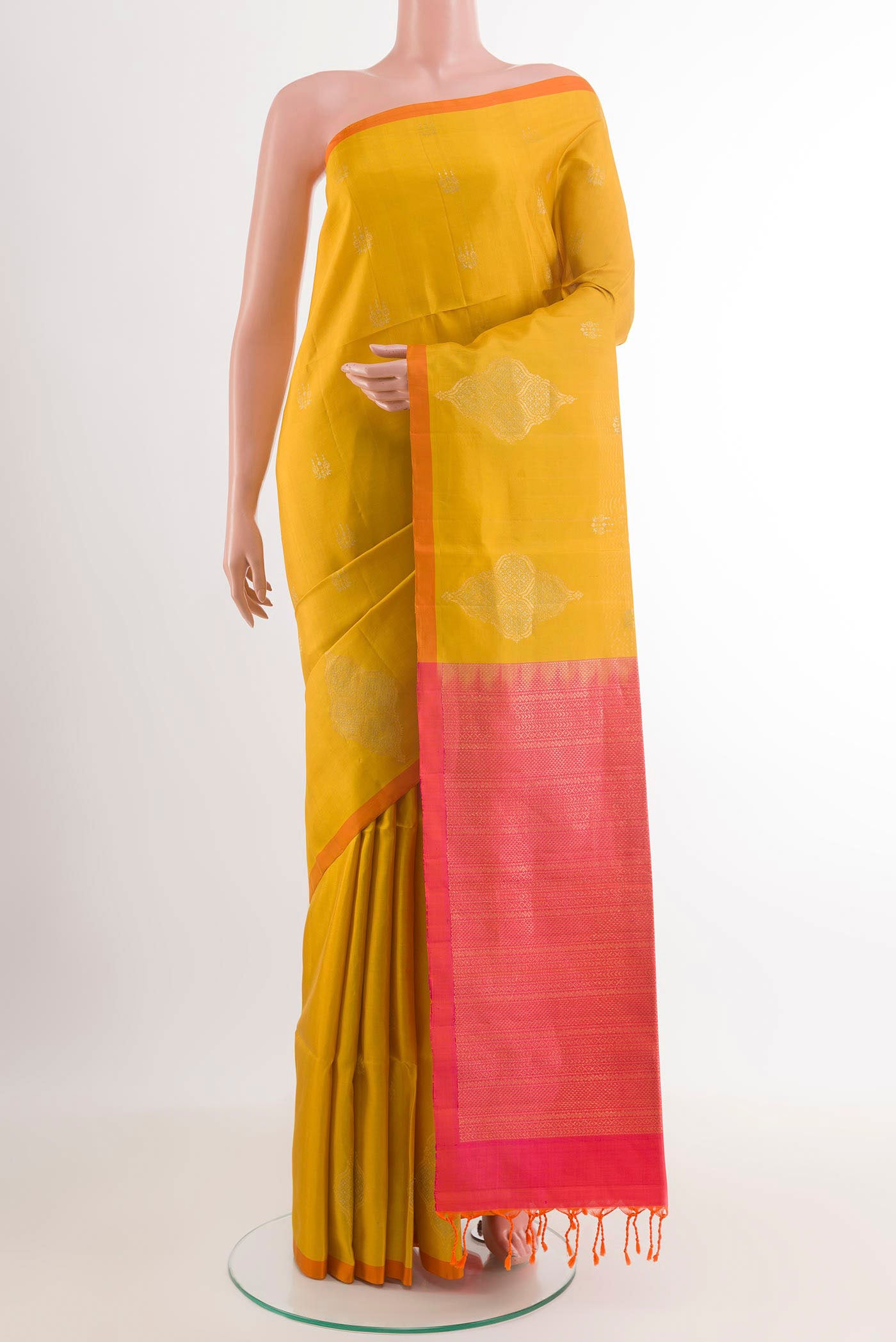 Yellow Soft Silk Saree with Zari Butta on the body and Zari Border.  displayed on a mannequin