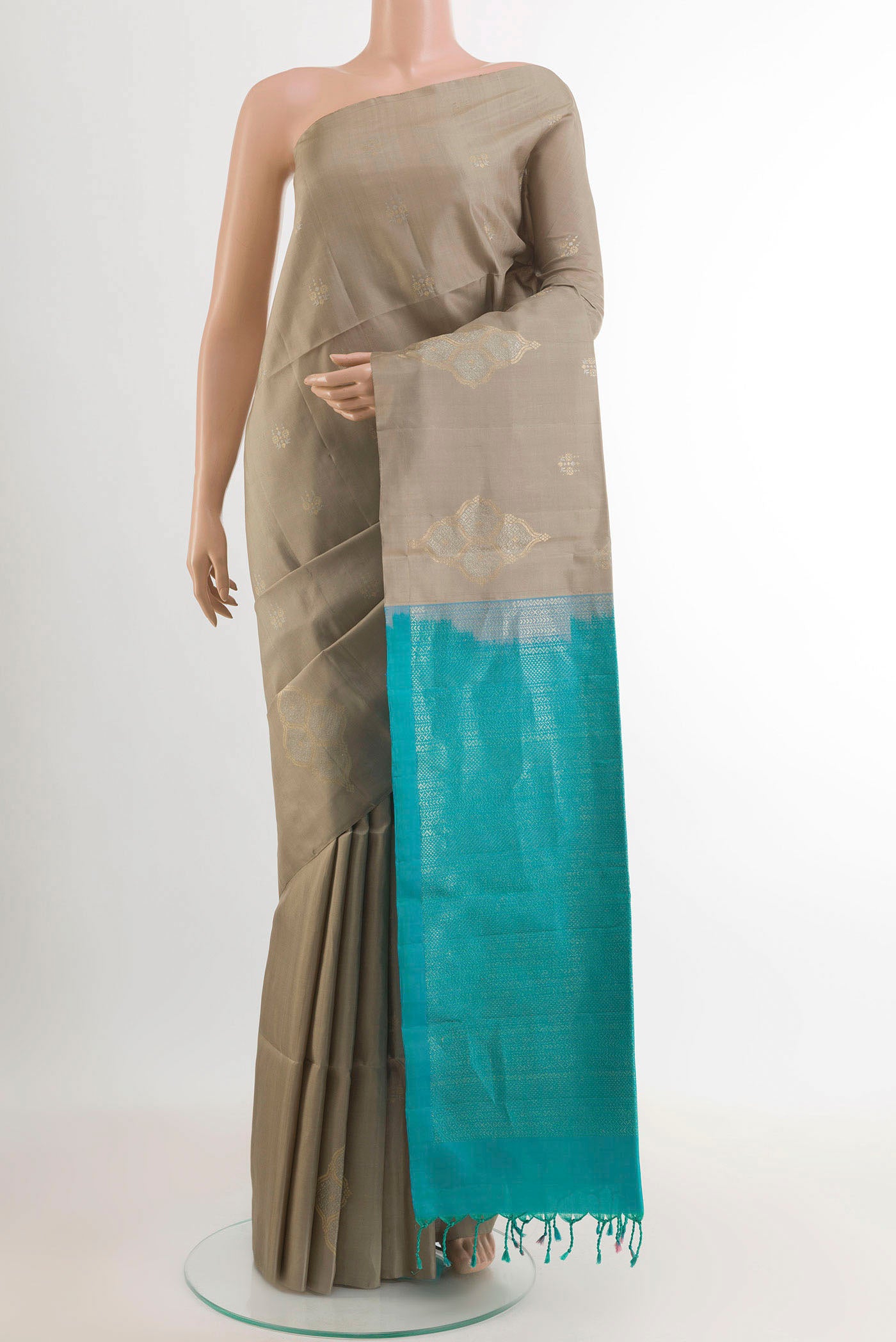 Grey Soft Silk Saree with Zari Butta on the body and Zari Border.  displayed on a mannequin