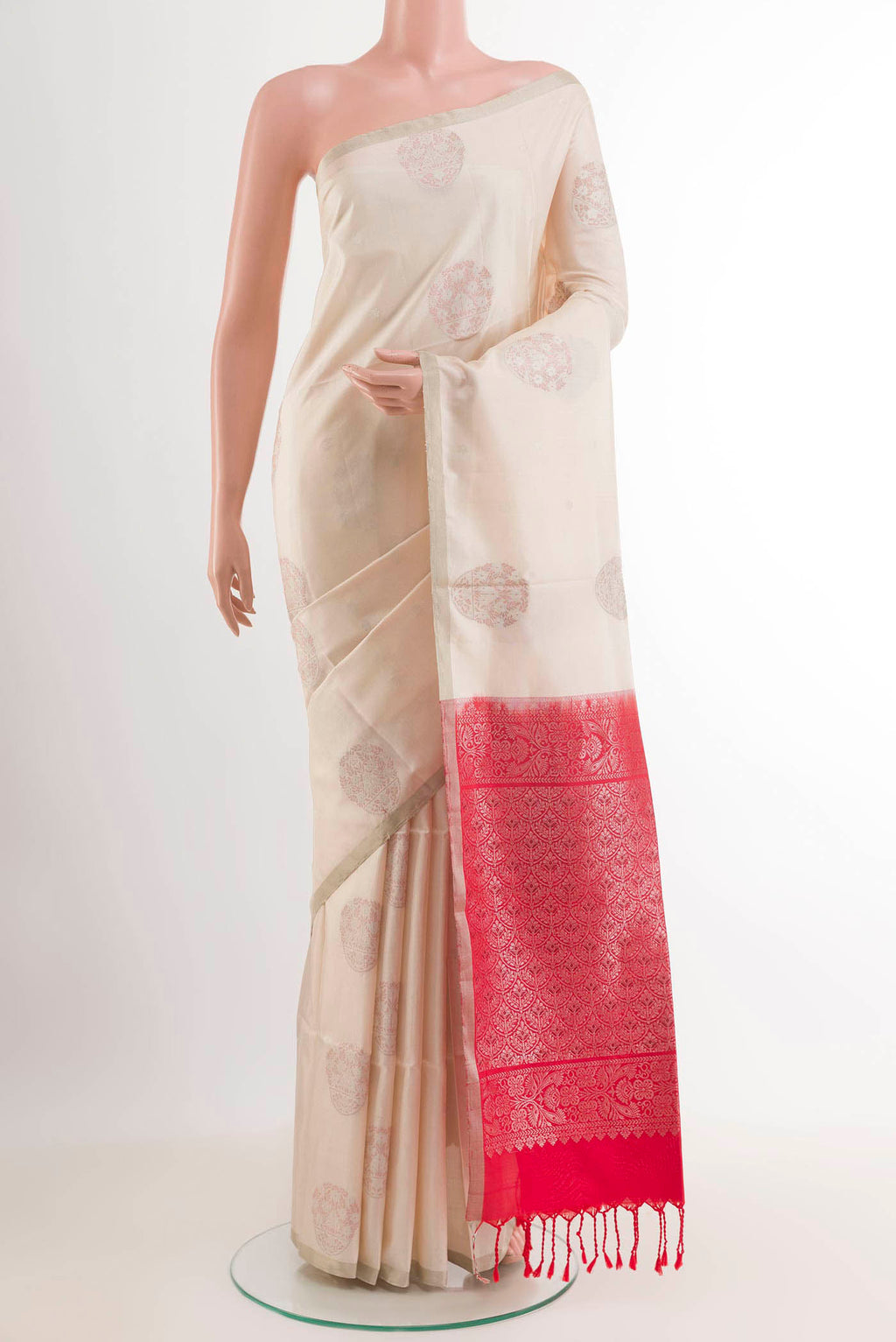 Off White Soft Silk Saree with Zari Butta on the body and Zari Border.  displayed on a mannequin