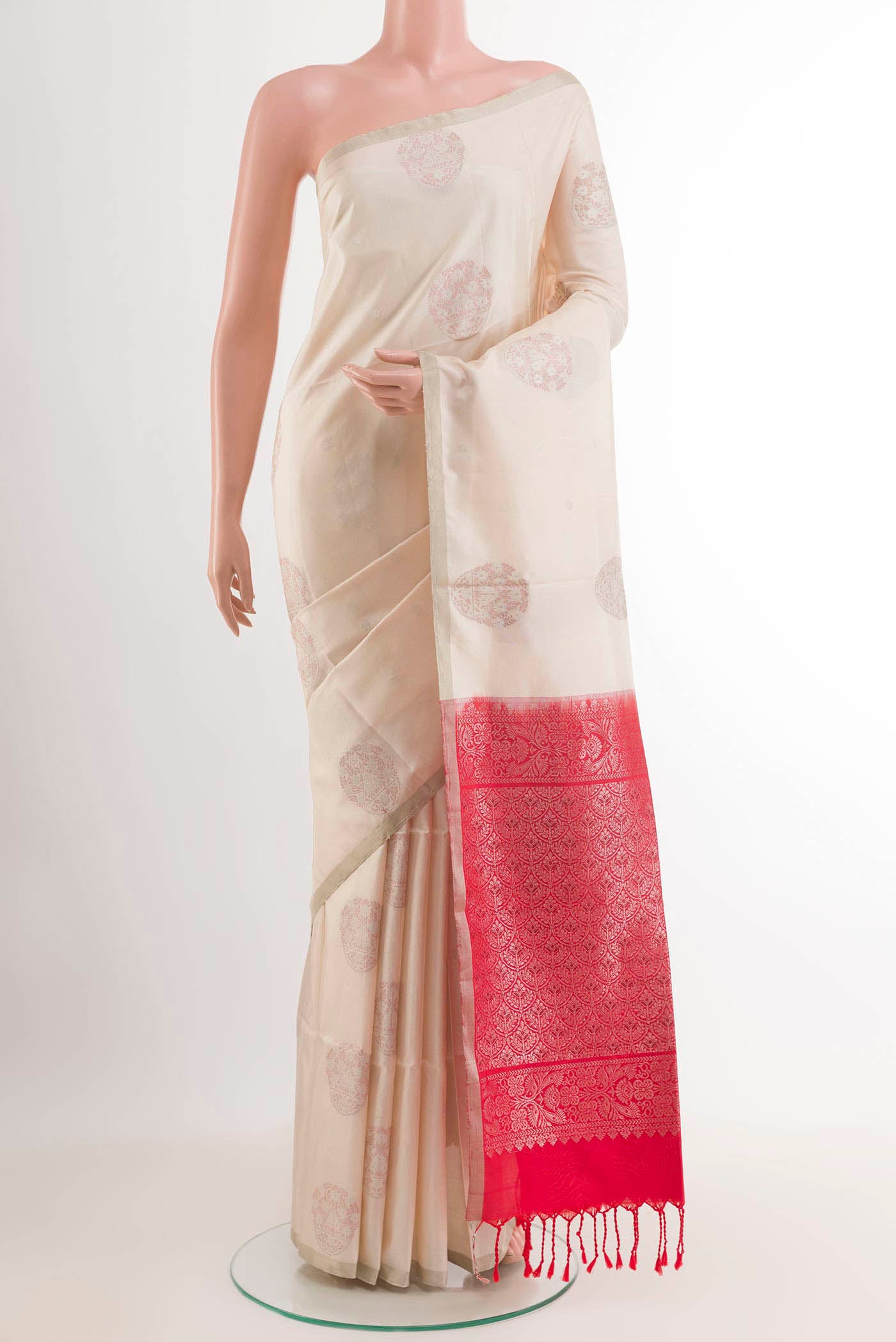 Off White Soft Silk Saree with Zari Butta on the body and Zari Border.  displayed on a mannequin