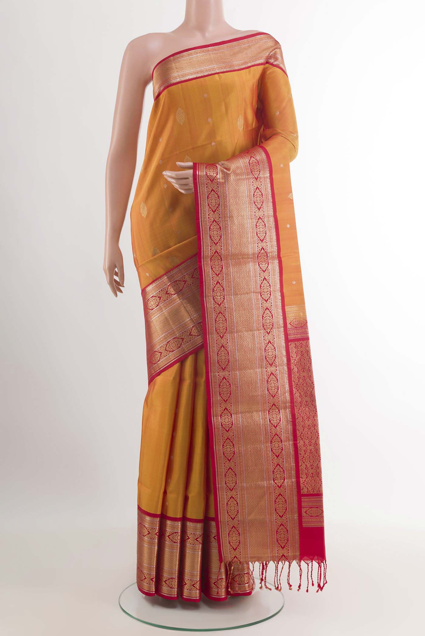 Mustard Soft Silk Saree with Zari Butta on the body and Zari Border.  displayed on a mannequin