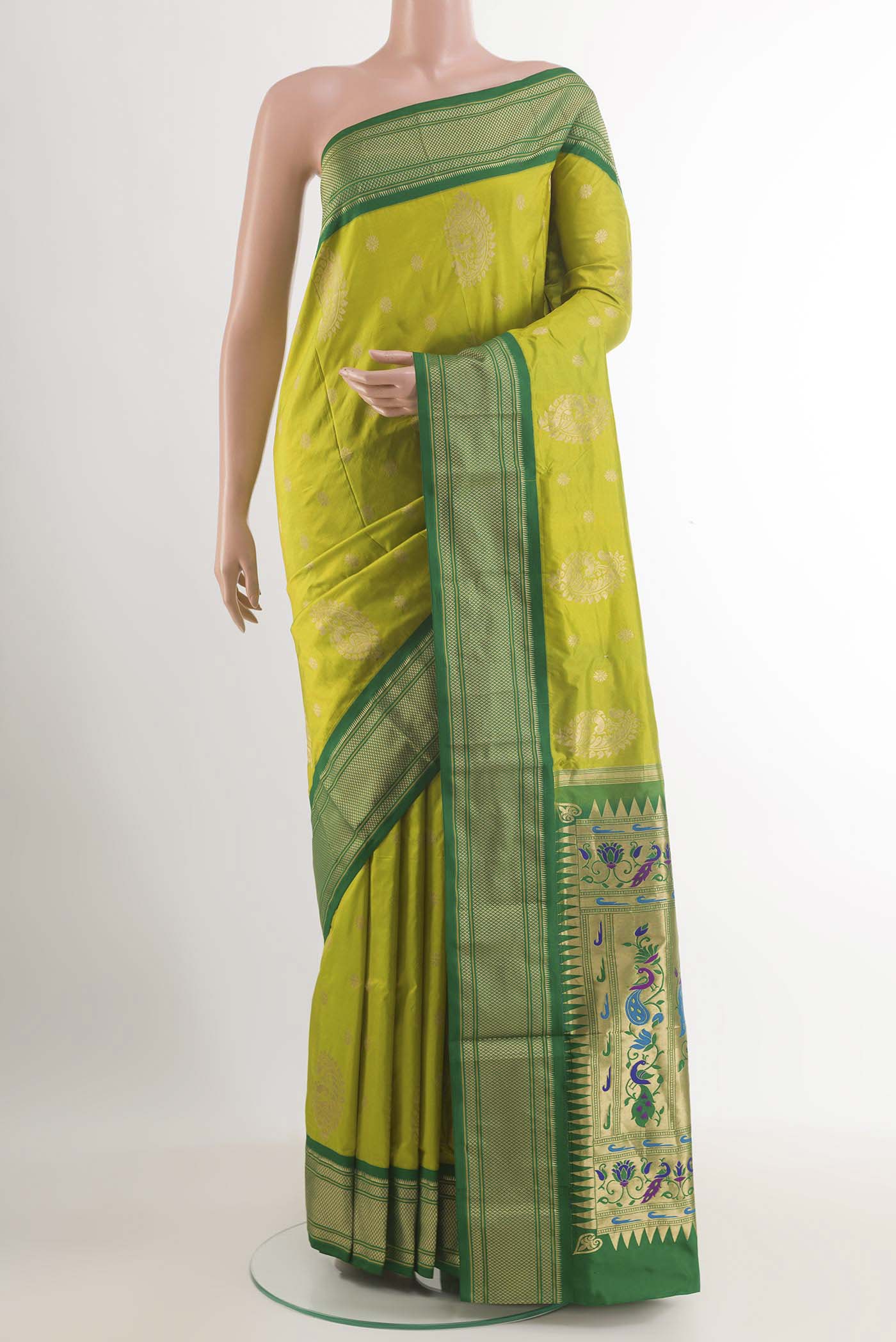Green Soft Silk Saree with Zari Butta on the body and Zari Border.  displayed on a mannequin