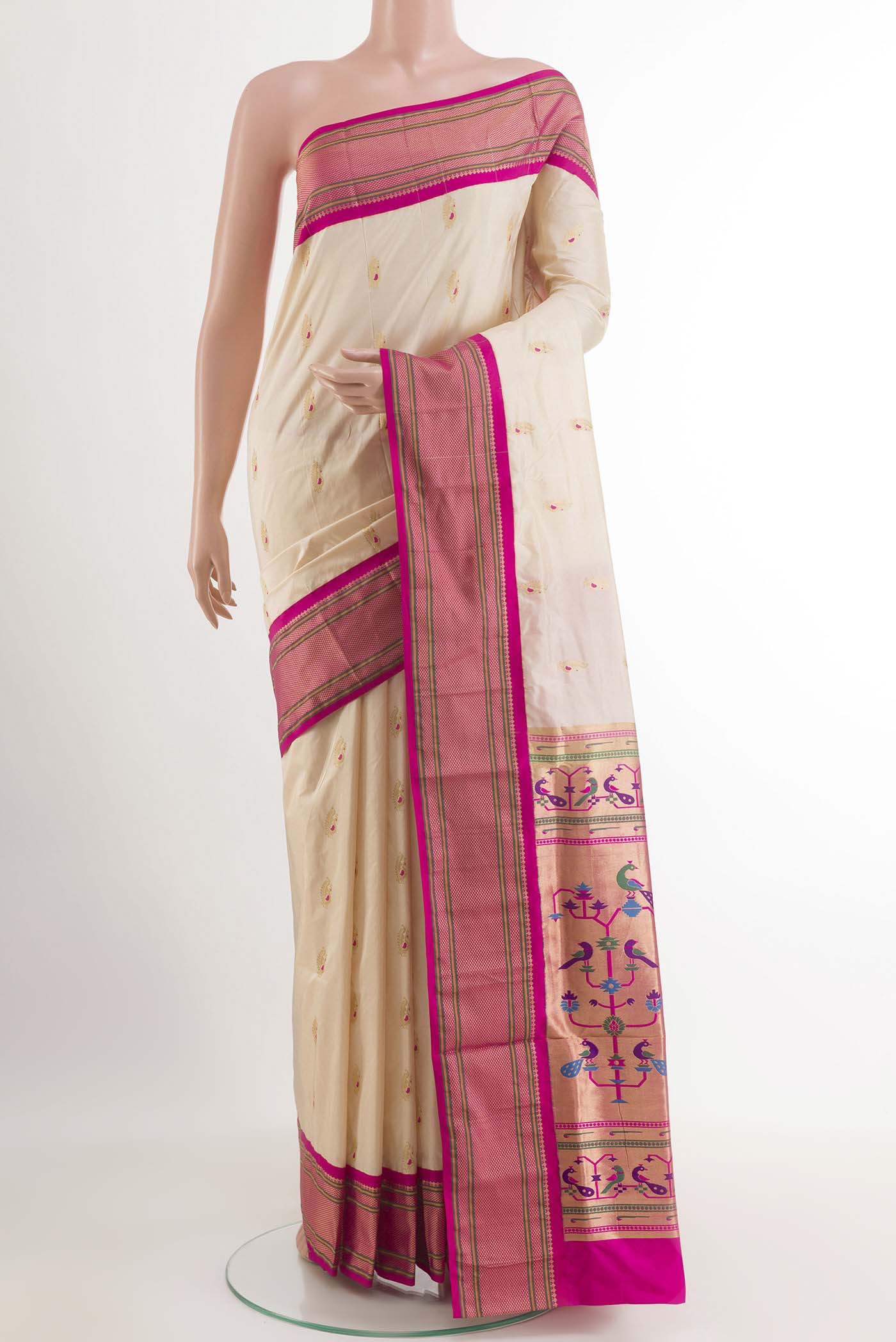 Cream Soft Silk Saree with Zari Butta on the body and Zari Border.  displayed on a mannequin