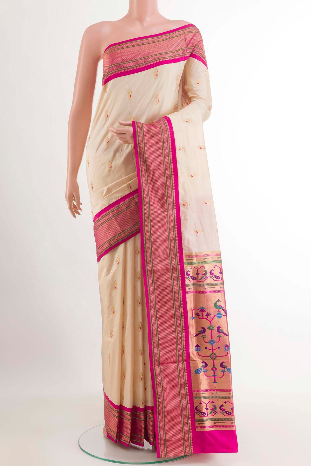 Cream Soft Silk Saree with Zari Butta on the body and Zari Border.  displayed on a mannequin