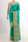 Sea Green Kanjivaram Silk Saree with Zari Butta on the body and Zari Border.  displayed on a mannequin