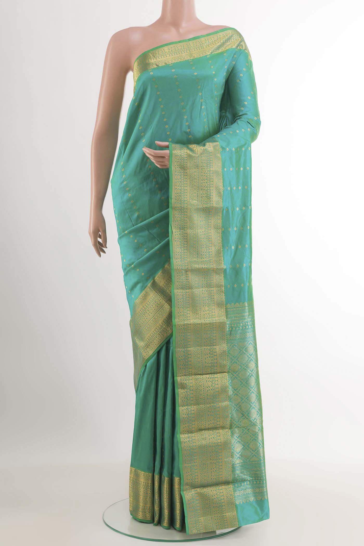 Sea Green Kanjivaram Silk Saree with Zari Butta on the body and Zari Border.  displayed on a mannequin