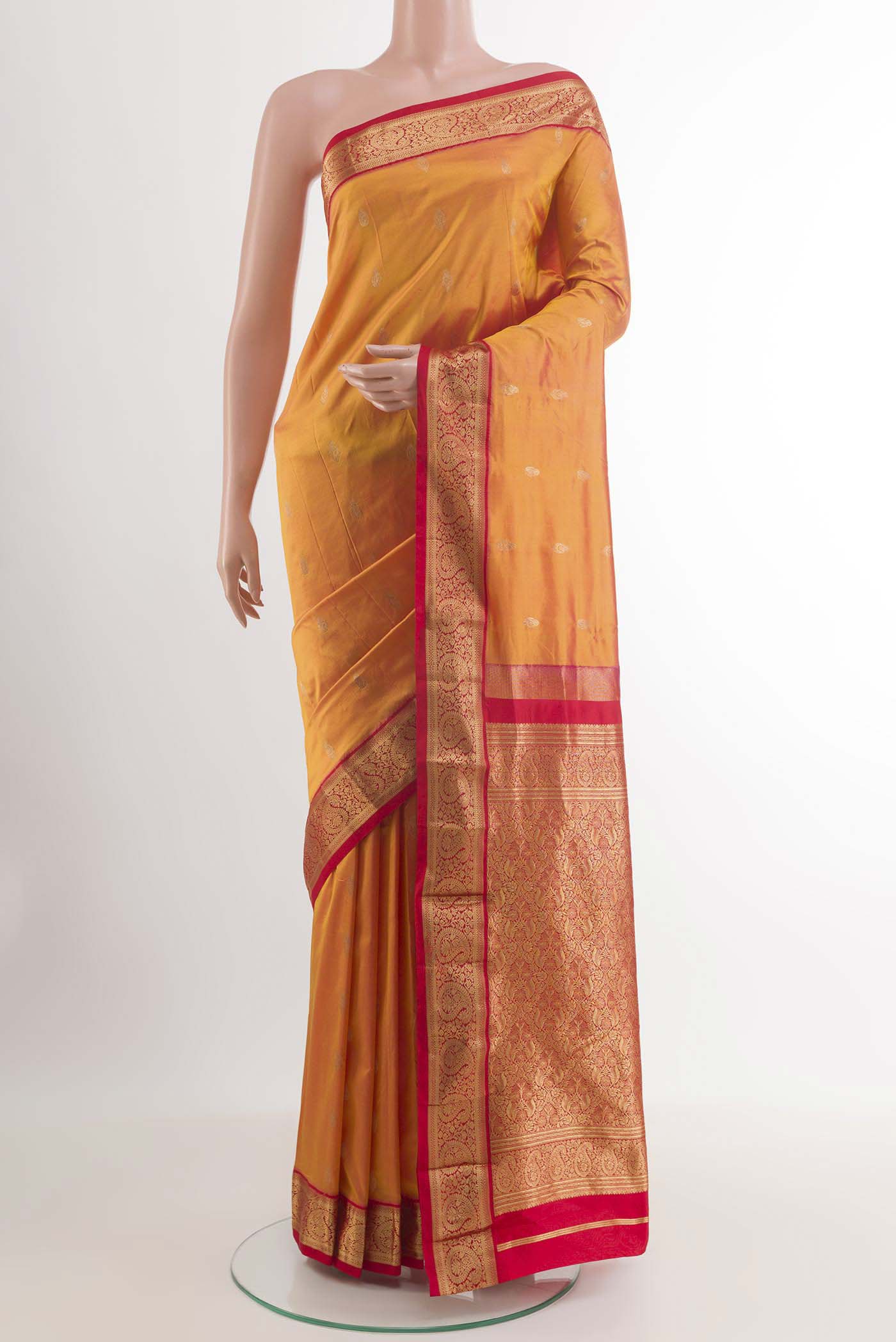 Orange Dual Tone Kanchipuram Silk Saree with Zari Butta on the body and Zari Border.  displayed on a mannequin