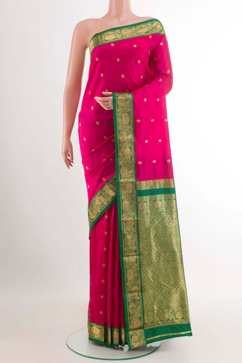 Rani Pink Kanchipuram Silk Saree with Zari Butta on the body and Zari Border.  displayed on a mannequin