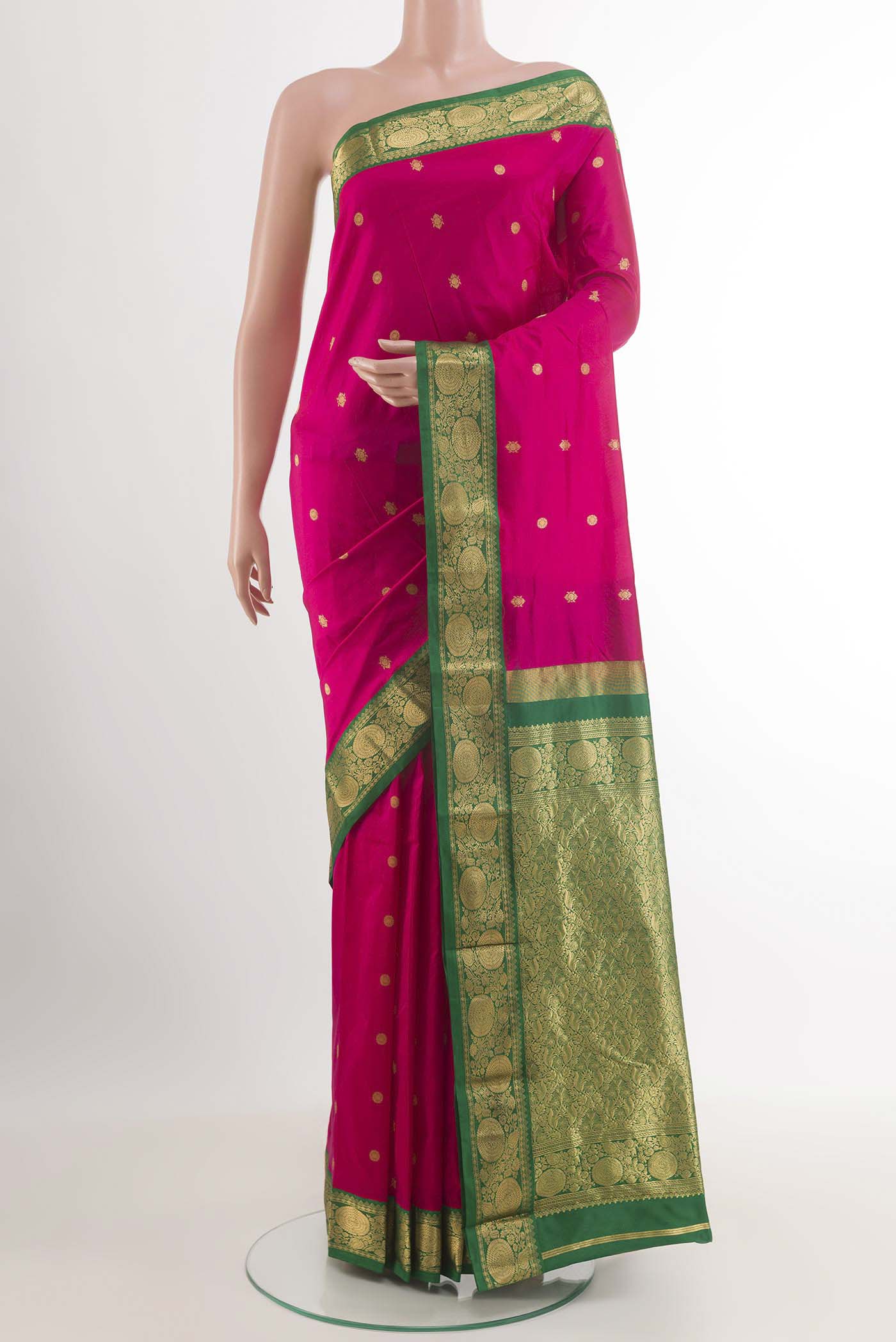 Rani Pink Kanchipuram Silk Saree with Zari Butta on the body and Zari Border.  displayed on a mannequin