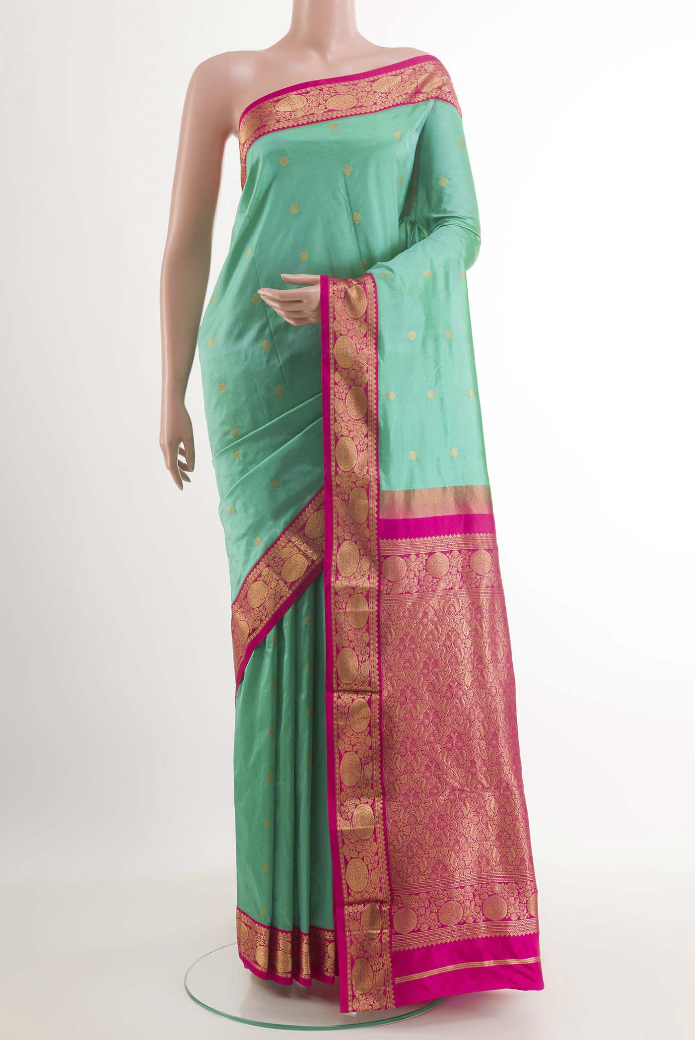 Sea Green Kanchipuram Silk Saree with Zari Butta on the body and Zari Border.  displayed on a mannequin