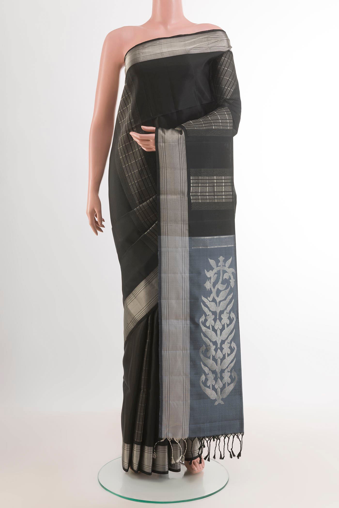 Black Soft Silk Saree with Zari Butta on the body and Zari Border.  displayed on a mannequin