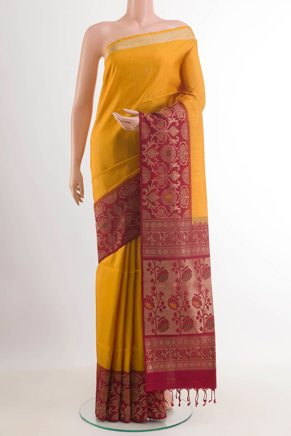 Yellow Soft Silk Saree with Zari Butta on the body and Zari Border.  displayed on a mannequin
