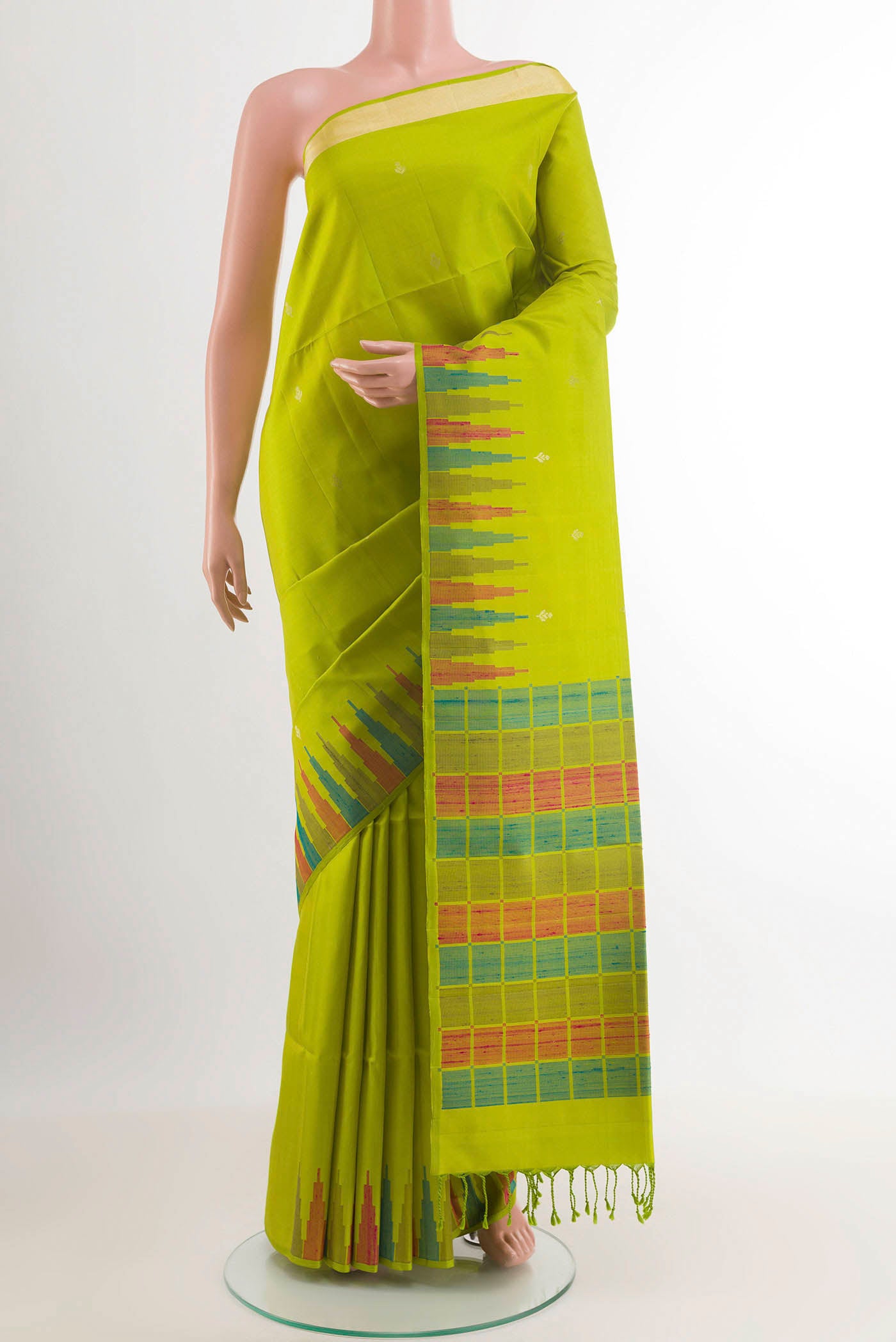 Parrot Green Soft Silk Saree with Zari Butta on the body and Zari Border.  displayed on a mannequin