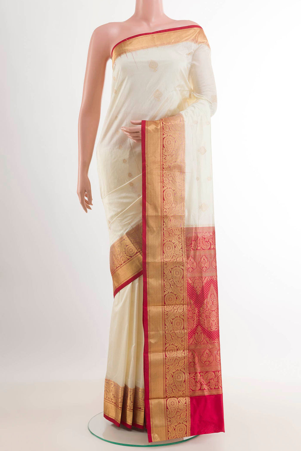 Off White Kanchipuram Silk Saree with Zari Butta on the body and Zari Border.  displayed on a mannequin