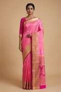Model wearing a Rose pink Bangalore Silk Saree with Zari Butta on the body and Zari Border.