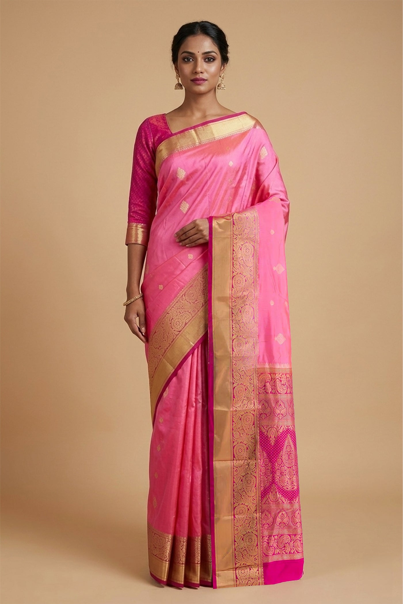 Model wearing a Rose pink Bangalore Silk Saree with Zari Butta on the body and Zari Border.