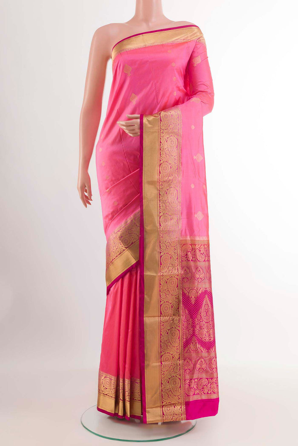 Rose pink Kanchipuram Silk Saree with Zari Butta on the body and Zari Border.  displayed on a mannequin