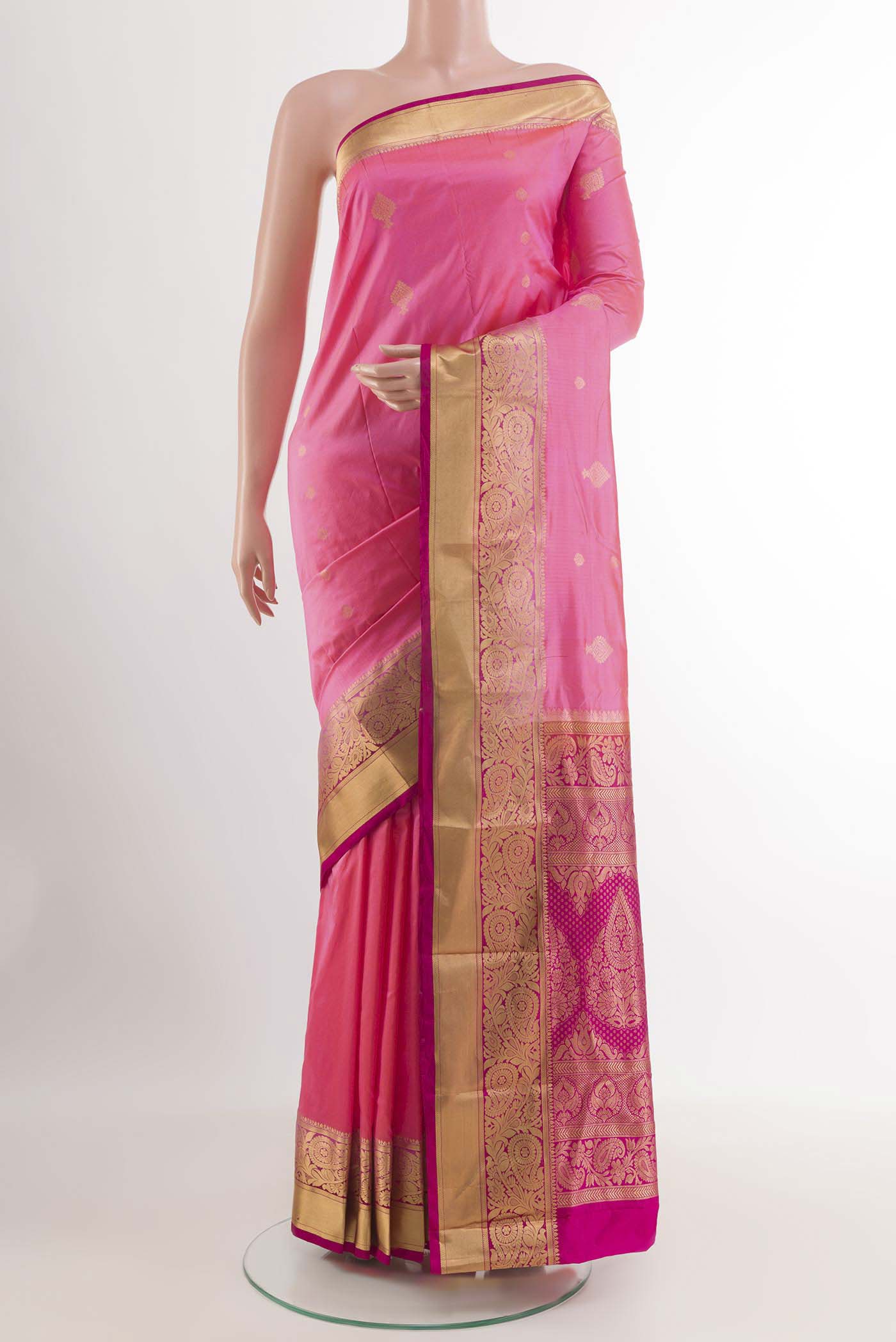 Rose pink Kanchipuram Silk Saree with Zari Butta on the body and Zari Border.  displayed on a mannequin