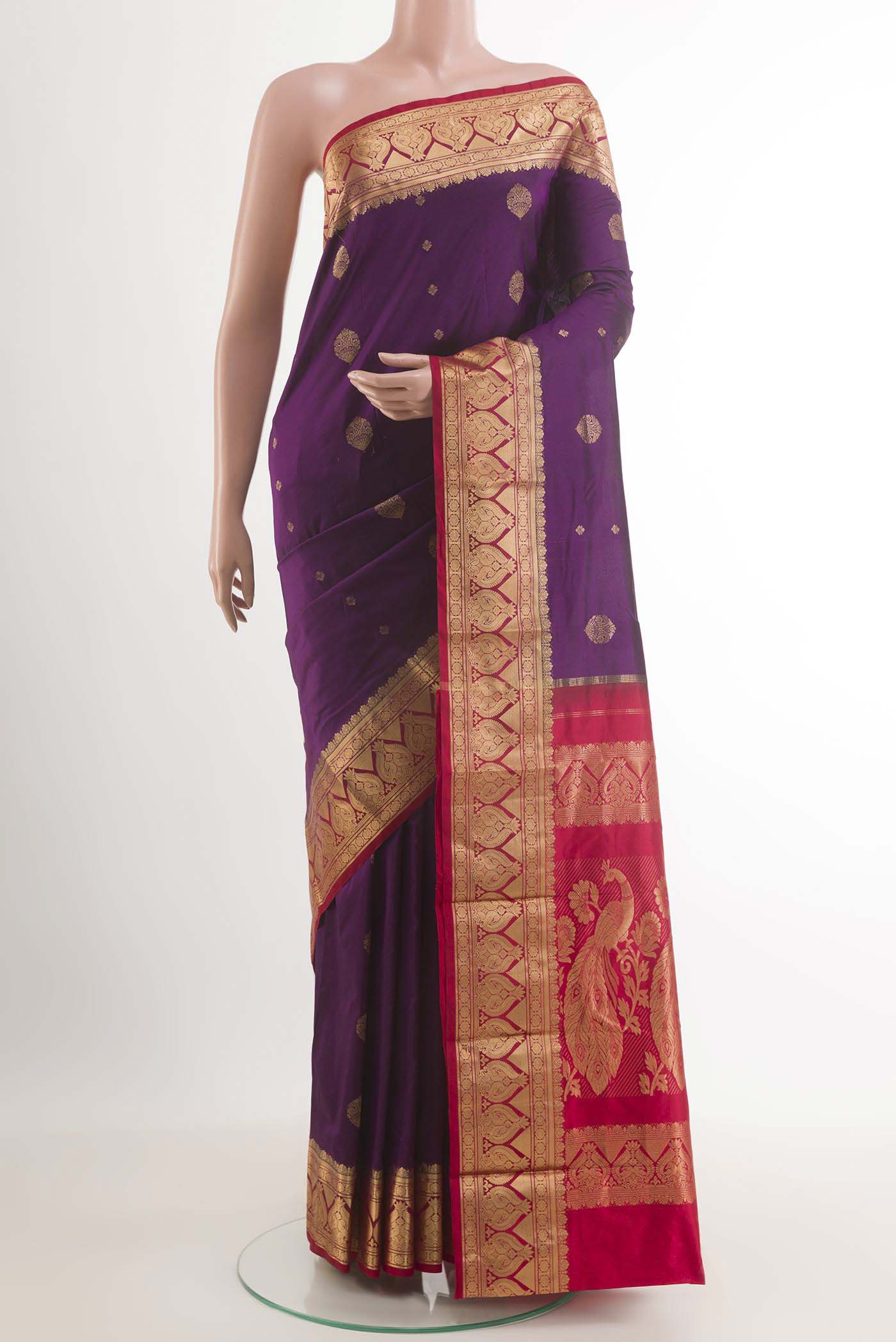 Purple Kanchipuram Silk Saree with Zari Butta on the body and Zari Border.  displayed on a mannequin